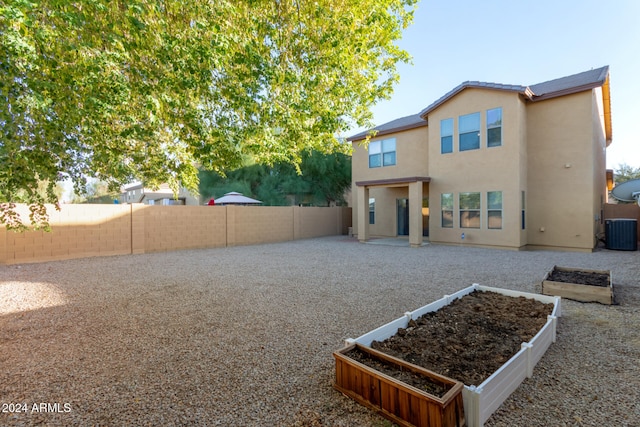 rear view of property featuring central AC unit