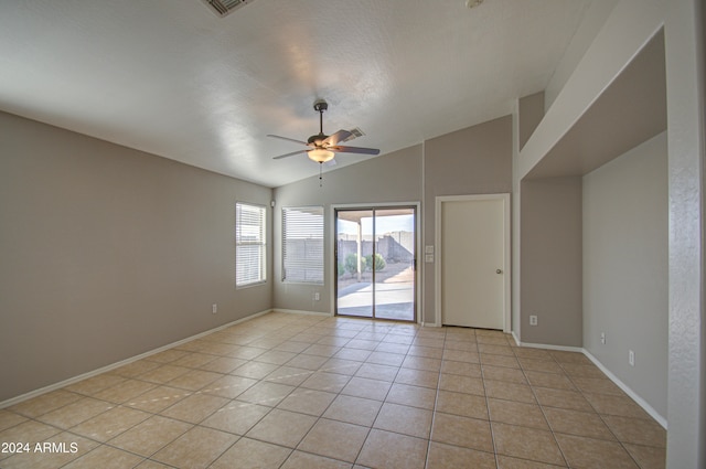 spare room featuring ceiling fan, light tile patterned floors, a textured ceiling, and high vaulted ceiling