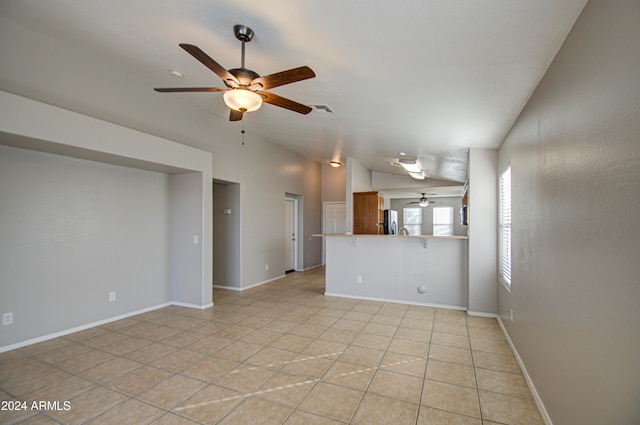 unfurnished living room with ceiling fan, light tile patterned floors, and lofted ceiling