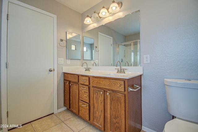 bathroom featuring tile patterned floors, walk in shower, vanity, and toilet