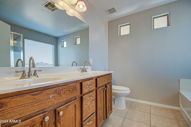 bathroom with tile patterned flooring, vanity, toilet, and a tub