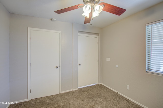 unfurnished bedroom with carpet, ceiling fan, and a closet