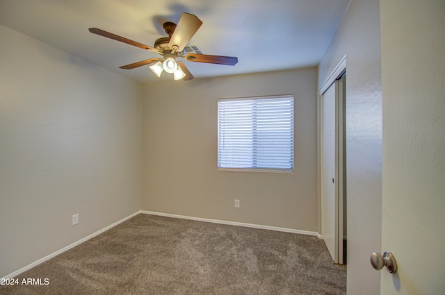 empty room featuring carpet flooring and ceiling fan