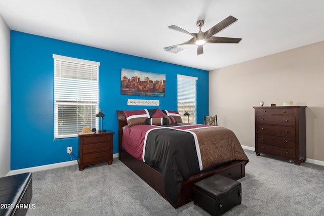 bedroom with ceiling fan and light colored carpet