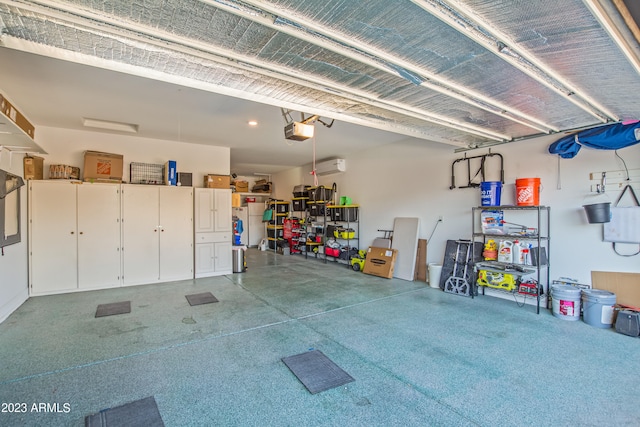 garage featuring a wall unit AC and a garage door opener