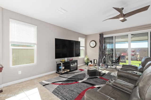 tiled living room with ceiling fan