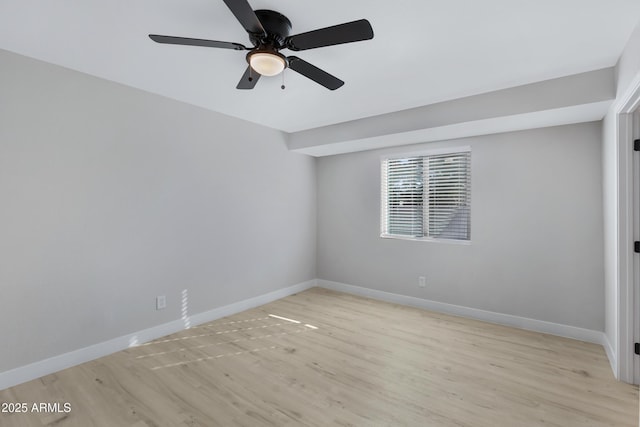 spare room with light wood-type flooring and ceiling fan