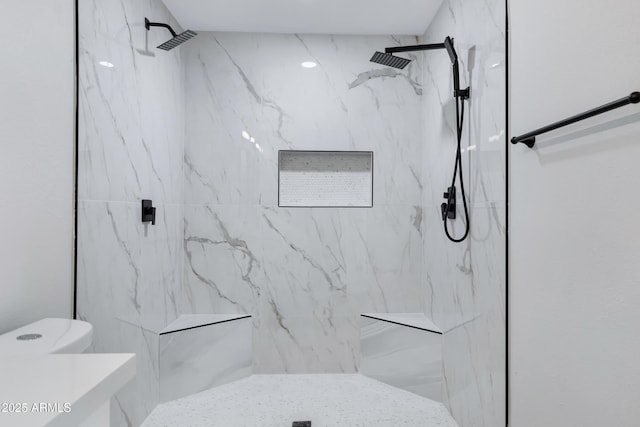 bathroom featuring toilet and tiled shower