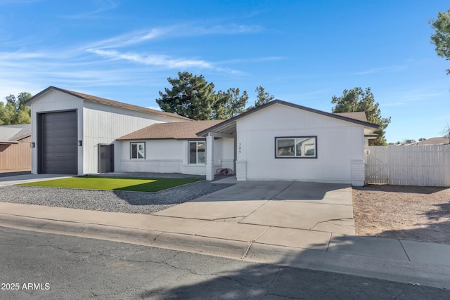 ranch-style home featuring a garage and a front lawn