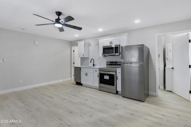 kitchen featuring light hardwood / wood-style floors, stainless steel appliances, ceiling fan, white cabinets, and sink