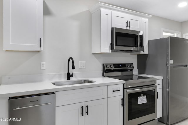 kitchen featuring sink, stainless steel appliances, and white cabinets