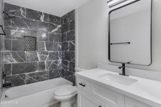 full bathroom featuring vanity, tiled shower / bath combo, and toilet