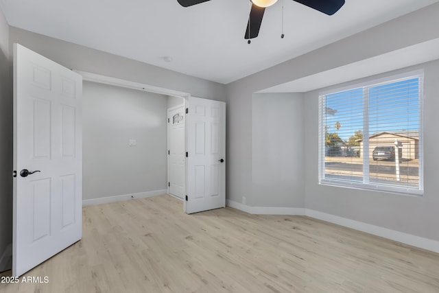 unfurnished bedroom with ceiling fan and light hardwood / wood-style flooring