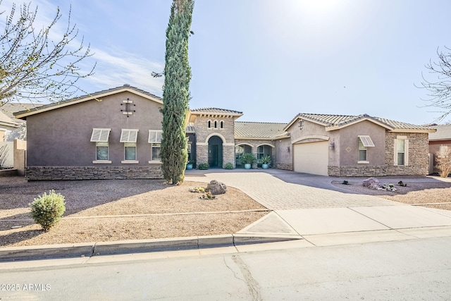 mediterranean / spanish house with a garage