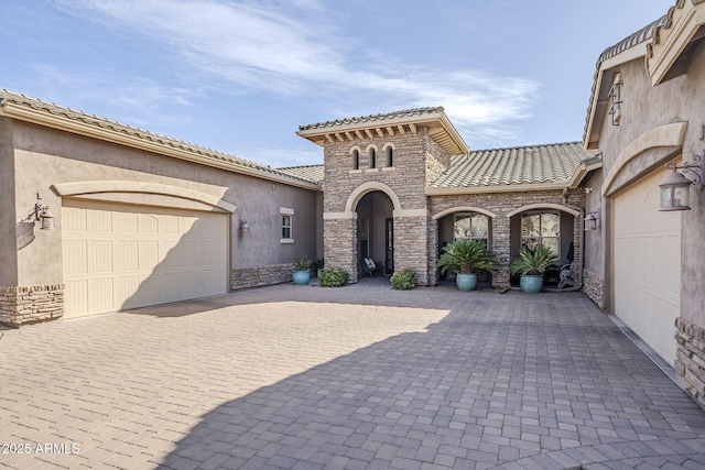 mediterranean / spanish house featuring a garage