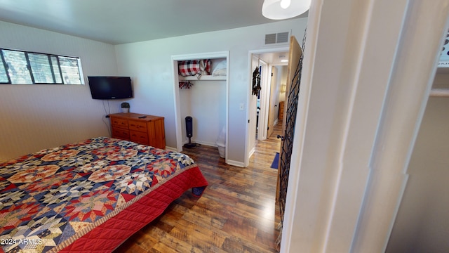 bedroom featuring a closet and dark hardwood / wood-style flooring