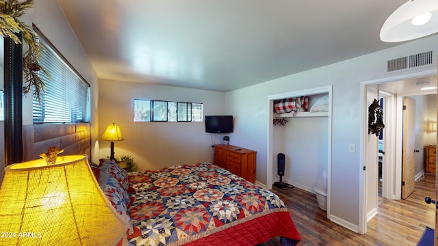 bedroom with a closet and hardwood / wood-style floors