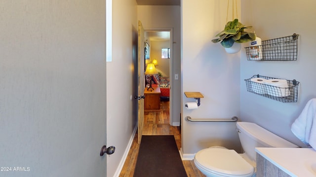 bathroom featuring toilet and wood-type flooring