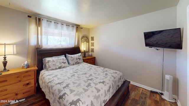 bedroom featuring dark hardwood / wood-style flooring