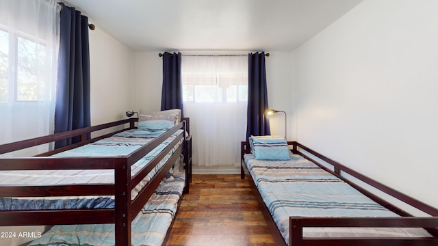 bedroom with dark hardwood / wood-style flooring