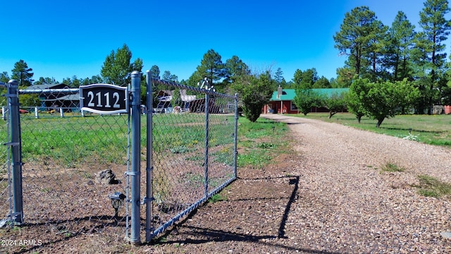 view of gate with a yard