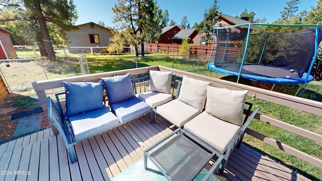 deck featuring an outdoor hangout area and a trampoline