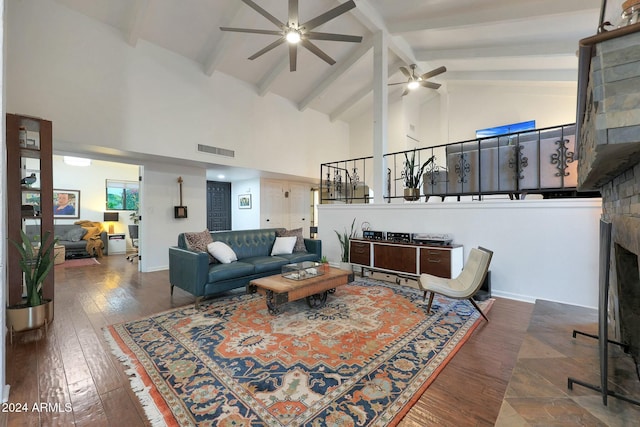 living room featuring ceiling fan, beamed ceiling, dark hardwood / wood-style floors, and high vaulted ceiling