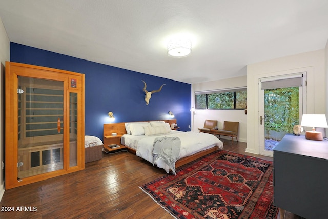 bedroom with dark hardwood / wood-style flooring and access to outside