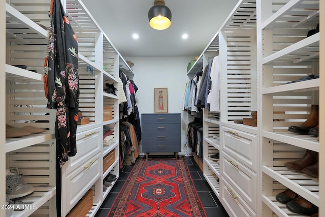 spacious closet featuring dark tile patterned flooring