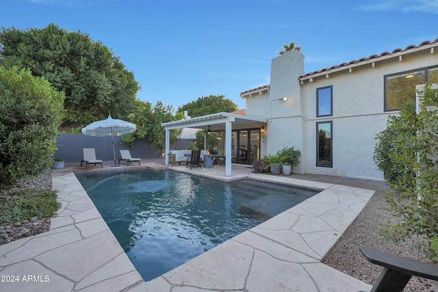 view of pool with ceiling fan and a patio area