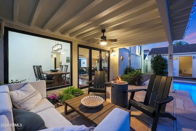 patio terrace at dusk featuring outdoor lounge area and ceiling fan