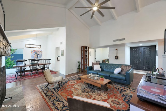 living room with beam ceiling, ceiling fan, hardwood / wood-style floors, and high vaulted ceiling