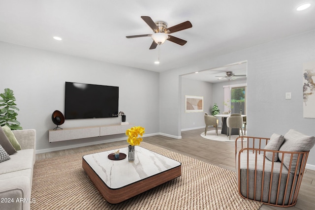 living room with ceiling fan and hardwood / wood-style floors