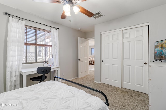 bedroom featuring ceiling fan, light colored carpet, and a closet