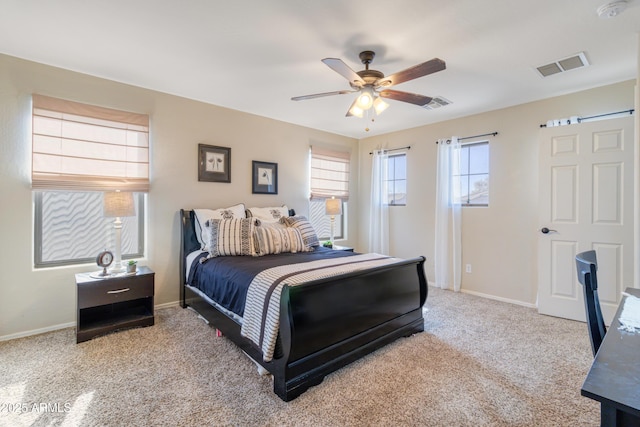 bedroom with ceiling fan and light carpet