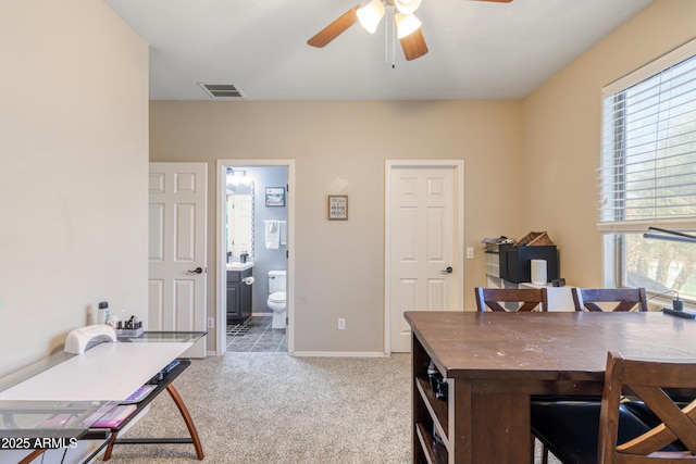 office space featuring light carpet and ceiling fan