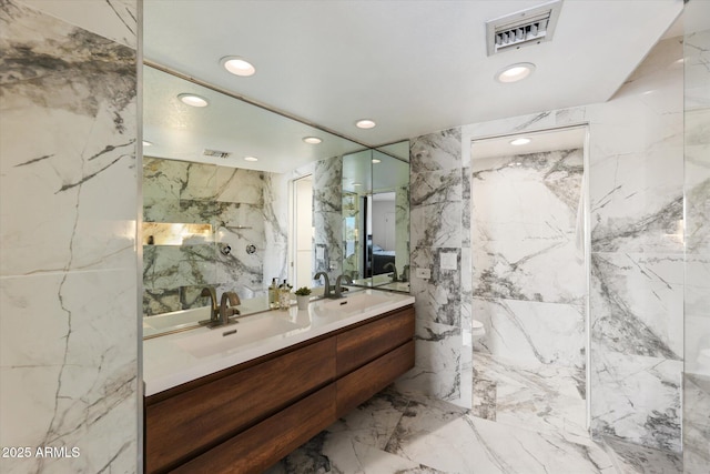 bathroom featuring tile walls and vanity