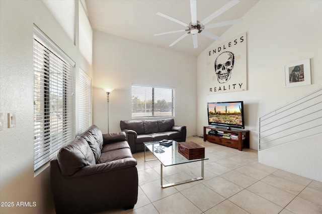 tiled living room featuring ceiling fan and high vaulted ceiling