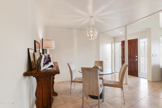 tiled dining space with an inviting chandelier