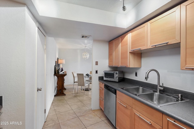 kitchen with a textured ceiling, light tile patterned flooring, stainless steel dishwasher, and sink