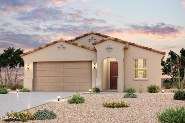 2182 S 246th Ln, Buckeye, AZ 85326 - mediterranean / spanish-style home with an attached garage, driveway, and stucco siding