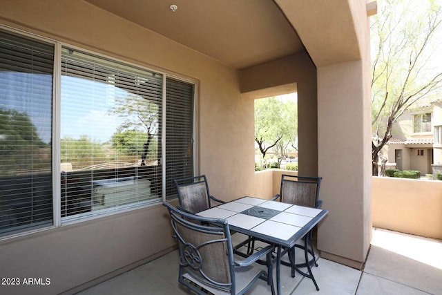 view of patio featuring outdoor dining area and a balcony