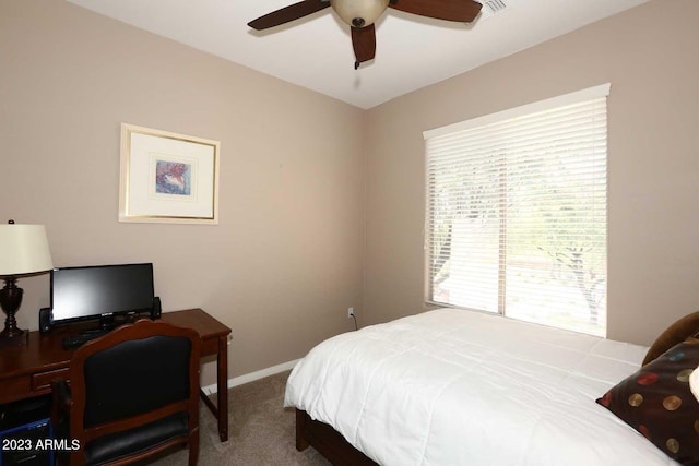 carpeted bedroom featuring a ceiling fan and baseboards