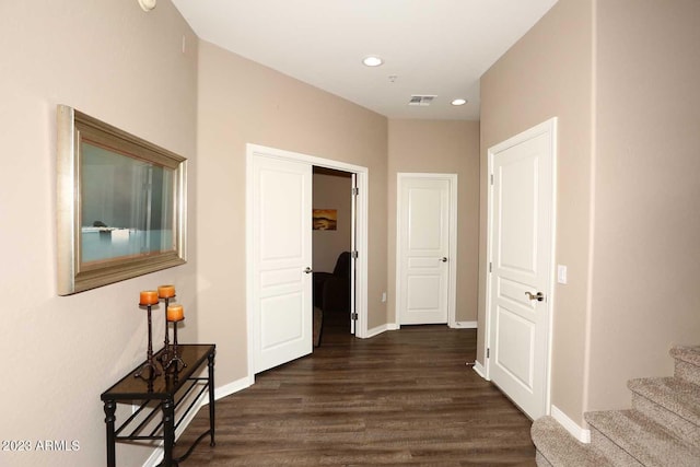 hall featuring visible vents, baseboards, dark wood finished floors, stairs, and recessed lighting