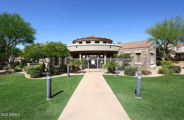 view of property's community with a gate, a lawn, and fence