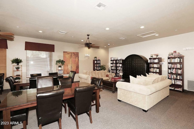 dining area with visible vents, attic access, carpet, and ceiling fan