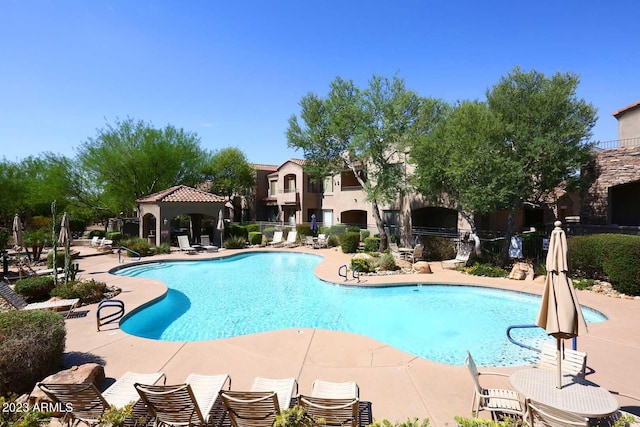 pool with a gazebo, a patio area, and fence