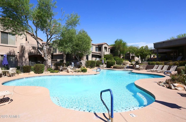 pool featuring a patio area and fence