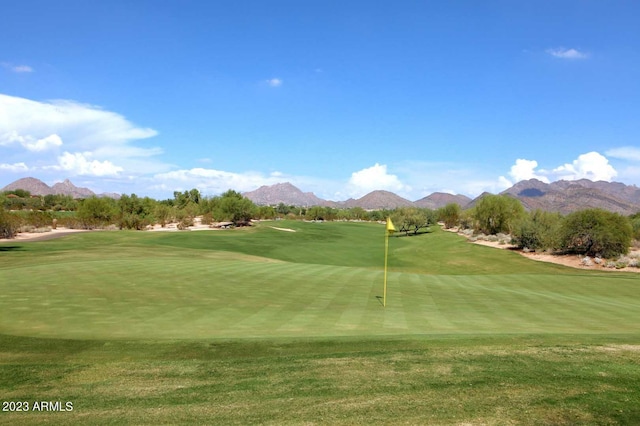 view of community with a lawn and view of golf course