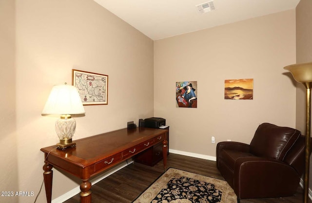 office area with visible vents, baseboards, and dark wood finished floors